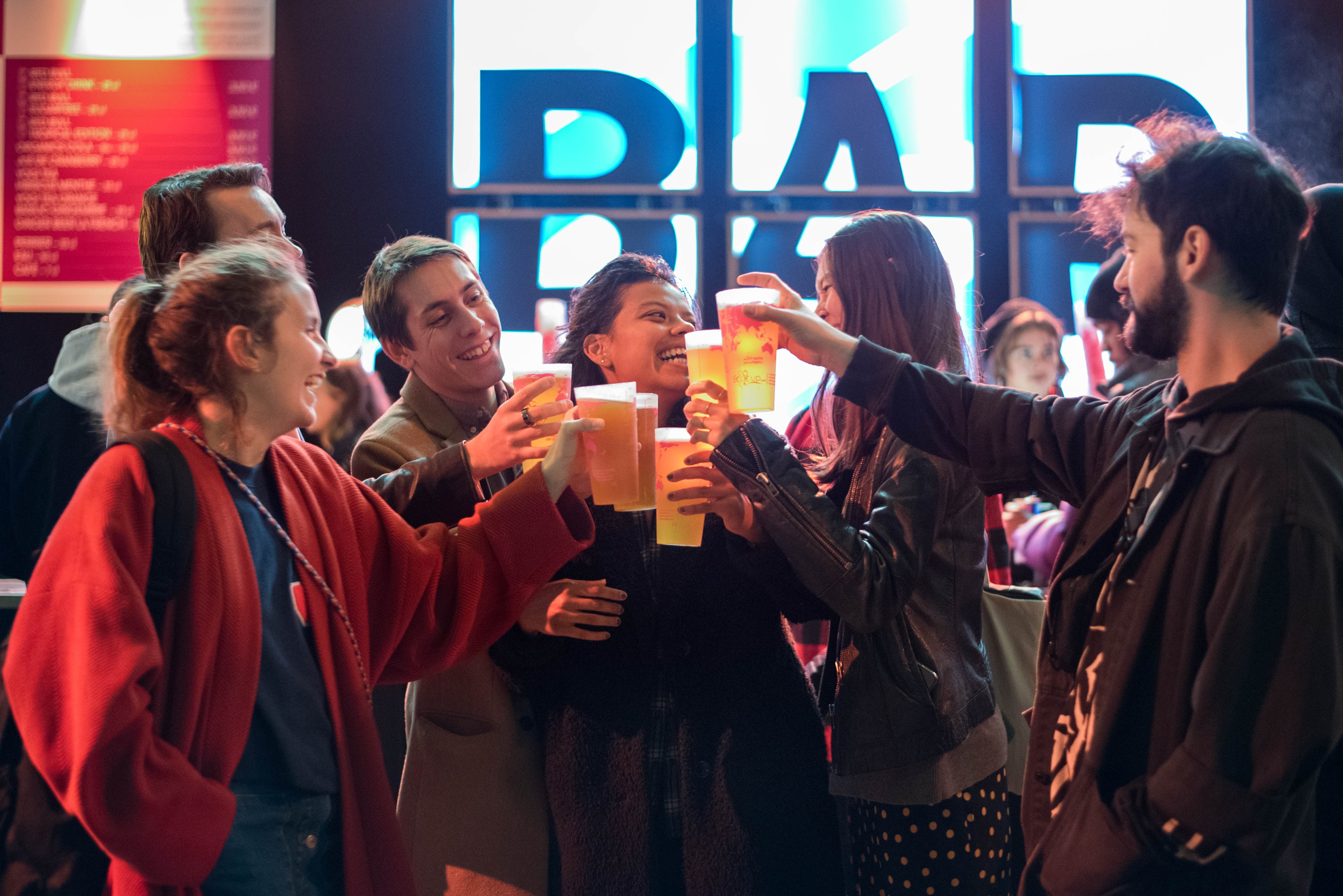 Young people toasting with personalized premium reusable cups